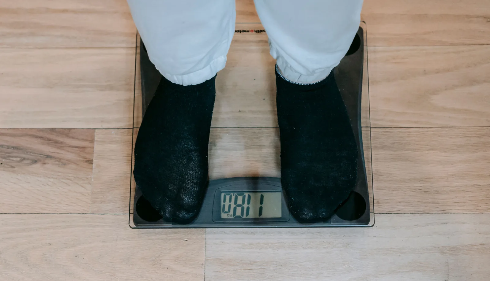 A digital bathroom scale showing a reading