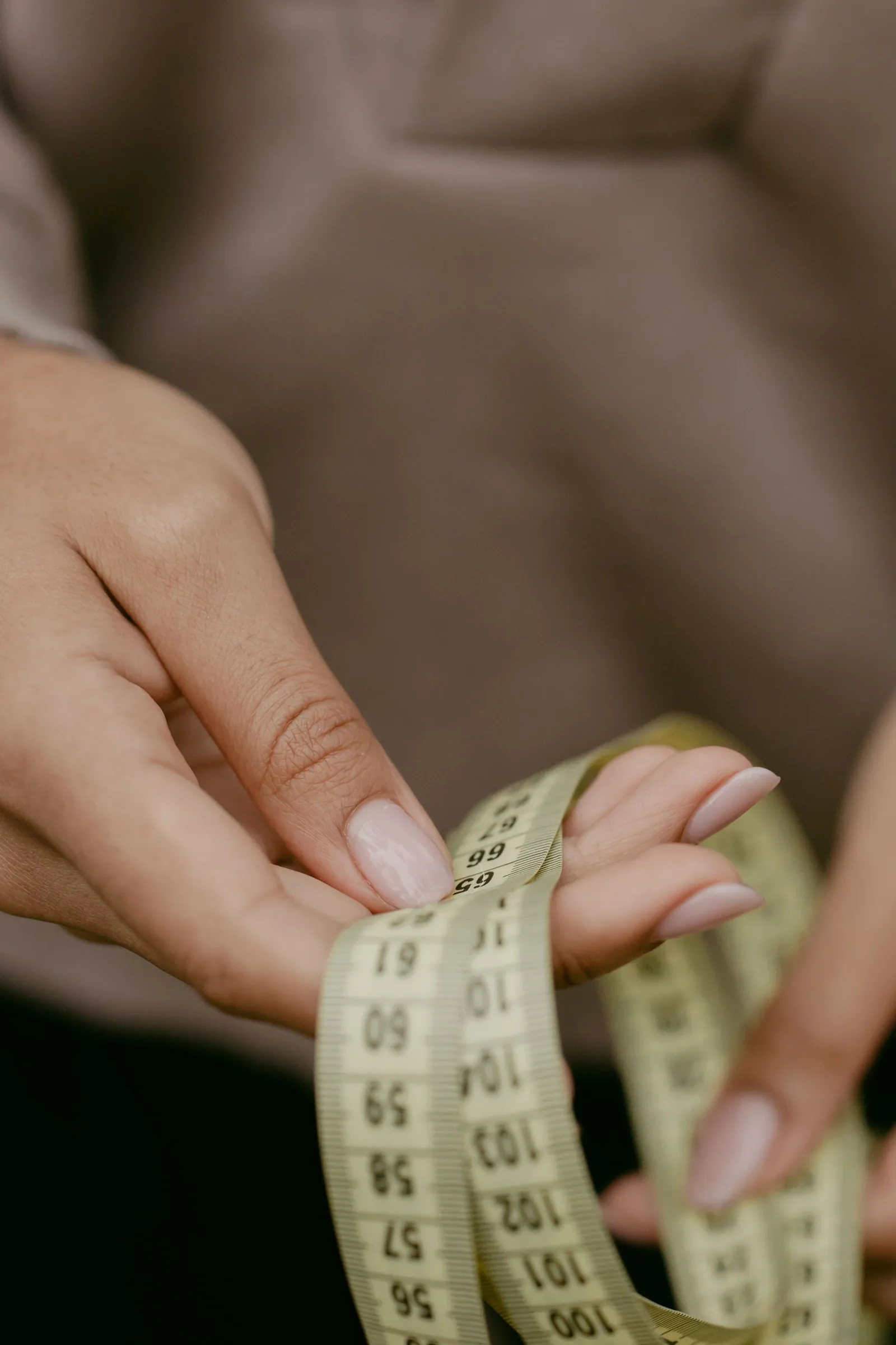 Hands holding a tape measure