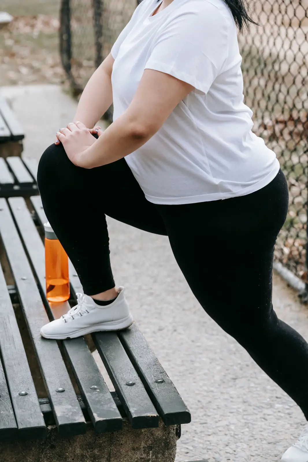 Stretching on a bench before a walk outdoors