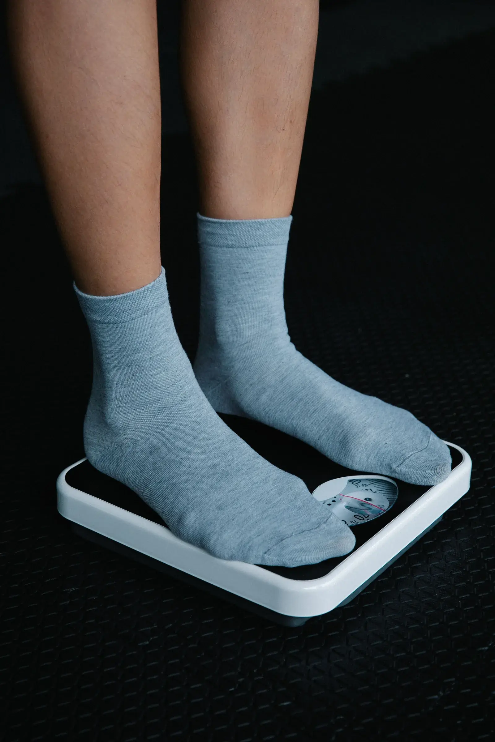 Standing on a bathroom scale in socks